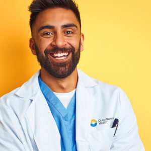 Young doctor with OBH logo on white coat
